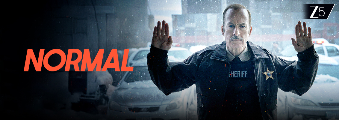 Bob Odenkirk as Sheriff Ulysses standing in a snowy small town in Normal, a dark crime thriller filled with mystery, action and suspense.